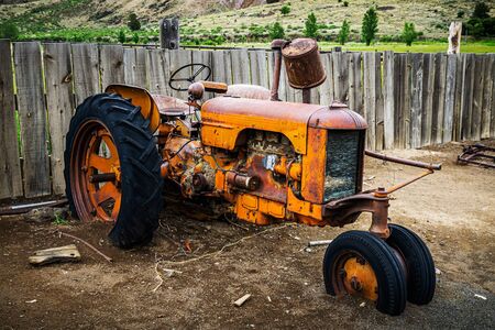 Old and rusty wreckage of a farm tractor, Cant Ranch, Oregon, USA.の写真素材