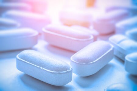 White tablets or pills or medication or drugs closeup. Selective focus. Pharmacy, medicine, medical treatment concept.の写真素材