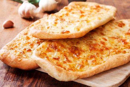 Italian Focaccia bread with garlic, rosemary and mozzarellaの写真素材