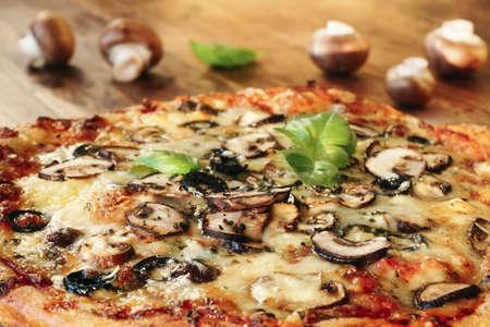 Homemade Mushroom Pizza with Basil Leaves and Olivesの写真素材