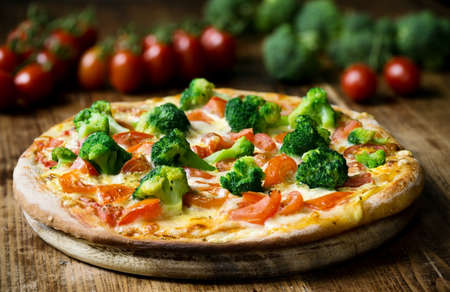 Homemade pizza with broccoli and tomatoの写真素材