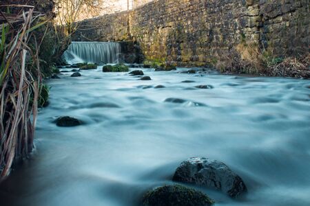 Small waterall and stream flowing through the village of Waddington, Ribble valley.