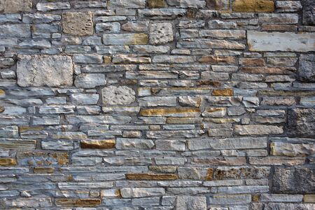 Flat stone wall background with various sized stones and textures