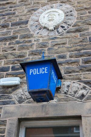 Old police lantern with a police crest above Clitheroe police station in the ribble valleyの写真素材