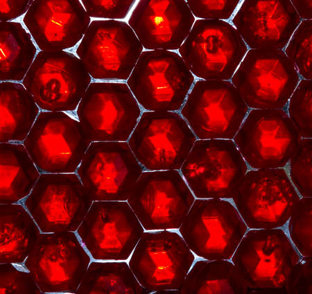 Close up of translucent red crystals. Red beads glittering and shining in the light
