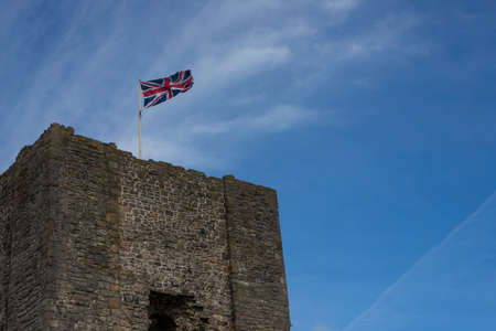 Clitheroe castle with a union jack flying. Small Norman castle in the Ribble valley with a blue summer skyのeditorial素材