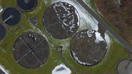 Aerial view of water treatment works creating patterns in the landscape. Polluted sewage being...