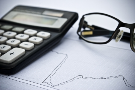 Chart, calculator, glasses as financial stock analysis conceptの写真素材