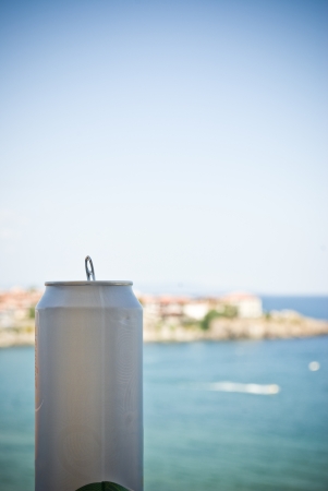 Beer can against bay and seaの写真素材