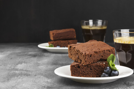 Brownie pieces and coffee on a dark backgroundの写真素材