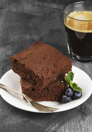 Brownie pieces and coffee on a dark backgroundの写真素材
