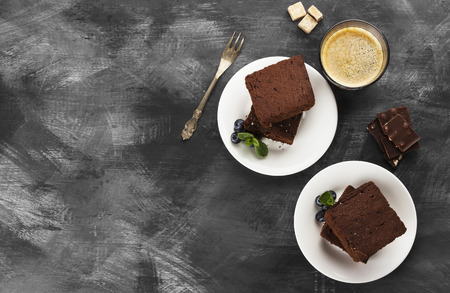 Brownie pieces and coffee on a dark backgroundの写真素材