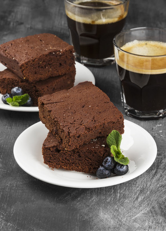 Brownie pieces and coffee on a dark backgroundの写真素材