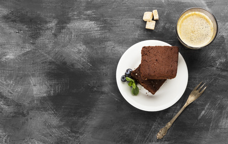Brownie pieces and coffee on a dark backgroundの写真素材