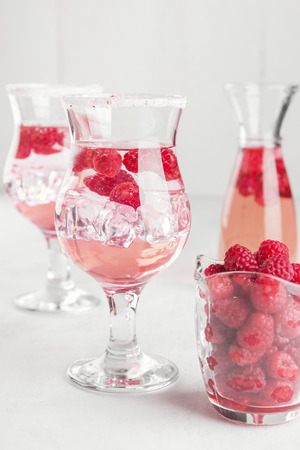 Summer cold drink with raspberry and ice on a white backgroundの写真素材