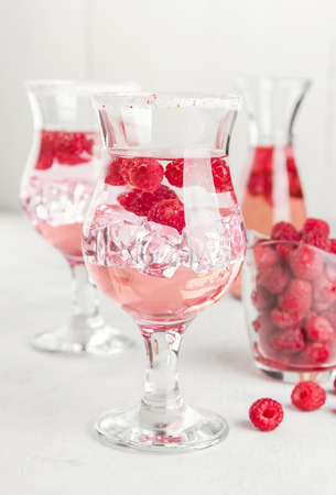 Summer cold drink with raspberry and ice on a white backgroundの写真素材