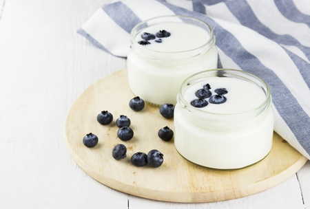 Yogurt with blueberry on a white backgroundの写真素材