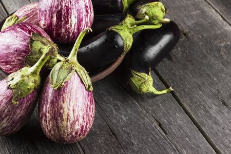 Various eggplants on a dark wooden backgroundの写真素材