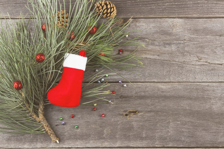 Fir-tree and Christmas jewelry on a wooden background. Space for text. Toningの写真素材