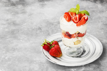 Dessert tiramisu with strawberry on a gray background. Copy space. Food backgroundの写真素材