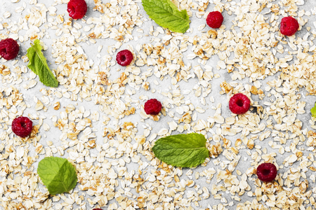 Glanola with raspberry and mint on a gray background. Top view, copy space. Food background