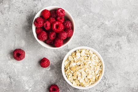 Glanola in glass jar with raspberry and mint on a gray background. Top view. Food backgroundの写真素材