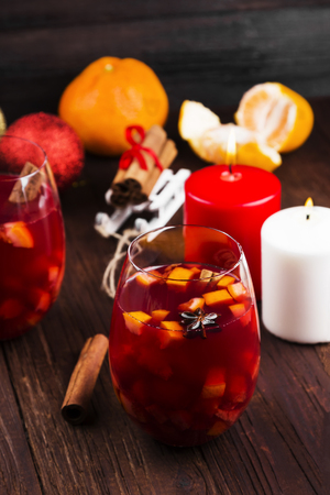 Christmas hot drink with citruses and spices - mulled wine on a wooden backgroundの写真素材