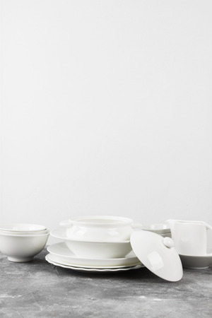 Clean white tableware on a gray backgroundの写真素材
