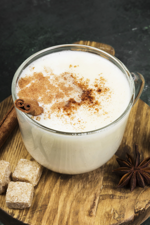Christmas drink eggnog and ingredients on a green backgroundの写真素材