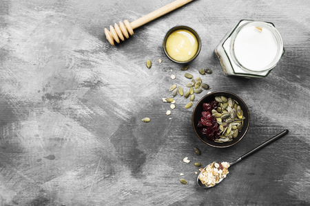 Granola with yogurt, honey, nuts, fruit on a dark background. Top view, copy space. Food backgroundの写真素材