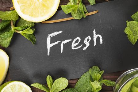 Detox drink with cucumber, lemon and mint on a wooden background. Top view. Food backgroundの写真素材