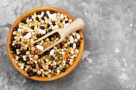 Assortment of beans (red lentil, green lentil, chickpea, peas, red beans, white beans, mix beans, mung bean) on gray background. Top view, copy space. Food backgroundの写真素材