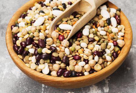 Assortment of beans (red lentil, green lentil, chickpea, peas, red beans, white beans, mix beans, mung bean) on gray backgroundの写真素材