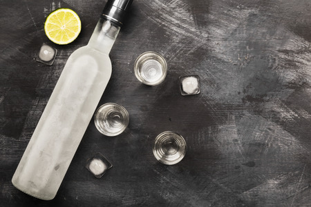 Cold vodka in shot glasses on a black background. Top view, copy space. Food backgroundの写真素材