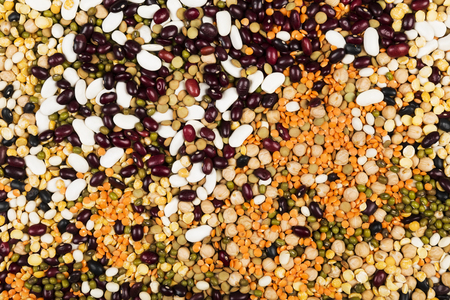 Assortment of beans (red lentil, green lentil, chickpea, peas, red beans, white beans, mix beans, mung bean) on gray background. Top view. Food backgroundの写真素材
