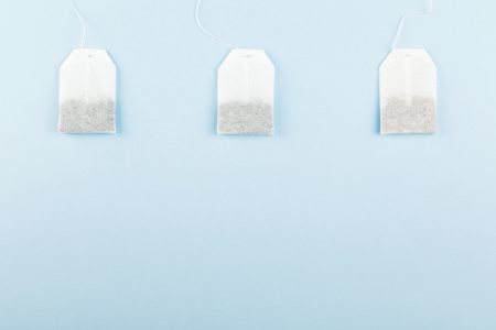 Tea bags on blue background. Top view, copy space. Food backgroundの写真素材