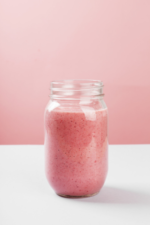 Strawberry smoothies on a pink backgroundの写真素材