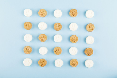 White and brown sugar smiles on blueの写真素材