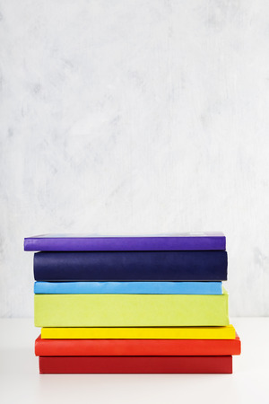 Stack of colorful rainbow books on white background. Copy spaceの写真素材