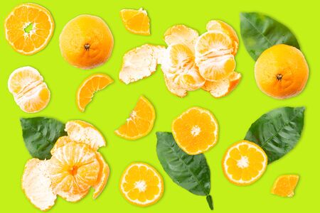 Slices of tangerine or orange. Fruit background. Flat lay, isolated on color background. Food background. Top viewの写真素材