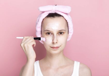 Young girl applies cosmetic mask with brush. Concept spa day at home, rest and relaxation