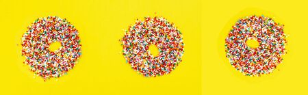 Multicolored sugar pastry topping in form of donuts on yellowの写真素材