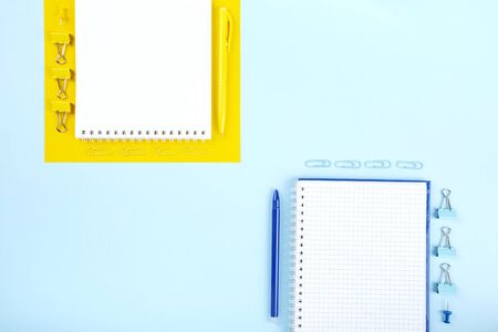 School office supplies on blue and yellow background. Back to school concept. Geometric and...