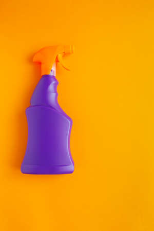 Detergents and cleaning products agent, orange background. Top view. Copy spaceの写真素材