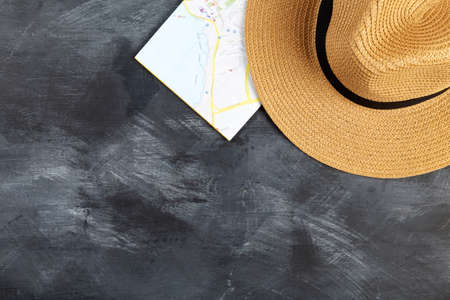 Travel accessories on table, black background. Top view. Copy space