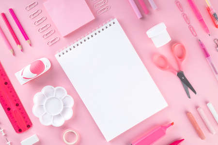 Various school office and painting supplies on pink background. Back to school concept. Geometric...