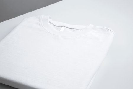 Basic folded white t-shirt. Mock up for branding t-shirt. copy space
