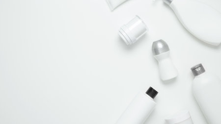 Cosmetic beauty products on white background. Bottles and tubes with branding mock up. Skin care and beauty concept. Top view, flat lay, copy space, bannerの写真素材