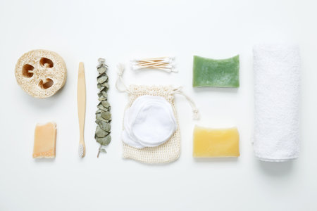 Natural organic eco cosmetics. Soap Eco, reusable cotton pads, natural sponge washcloth, cotton swab, eucalyptus leaves, towel on white background. Flat lay, top viewの写真素材