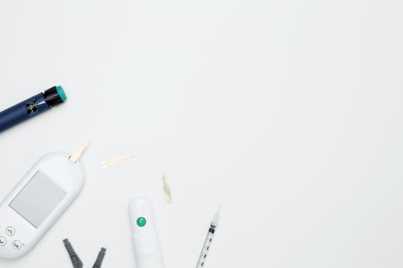 Diabetes concept with glucometer, syringe pen with insulin, blood test strips. Concept of worldwide diabetes awareness. Top view. Copy spaceの写真素材